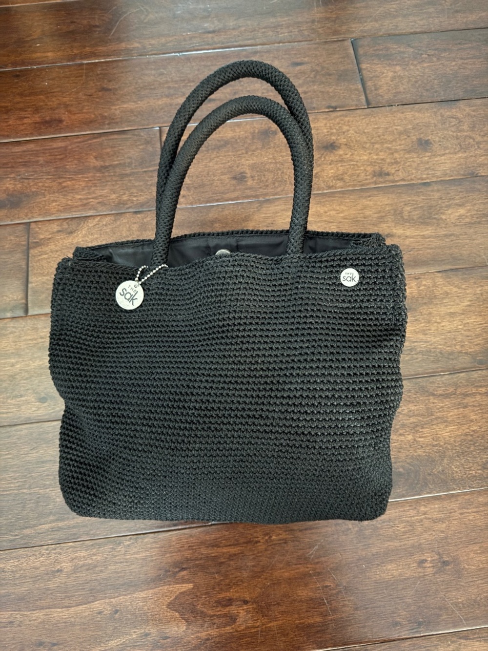 The Sak black crocheted small tote with cosmetic pouch
